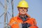 Portrait of a smiling engineer, foreman or worker with protective clothing and hard hat