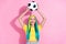 Portrait of smiling excited girl catch football big fan support with cyan hair isolated on pink color background