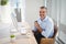 Portrait of smiling executive sitting at desk