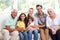 Portrait of smiling family with baby while sitting on sofa