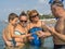 Portrait smiling family playing with the crab in the sea, ocean. Positive human emotions, feelings, joy. Funny cute child making v