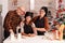 Portrait of smiling family standing at table in xmas decorated culinary kitchen