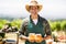 Portrait of a smiling farmer holding box of fruit