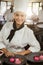 Portrait of smiling female chef finishing dessert plates