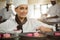 Portrait of smiling female chef finishing dessert plates