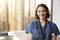 Portrait Of Smiling Female Doctor Wearing Scrubs With Stethoscope In Hospital Office