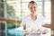 Portrait of smiling female masseur holding tray