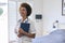 Portrait Of Smiling Female Nurse Wearing Uniform With Digital Tablet In Private Hospital Room