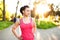 Portrait of a smiling female runner preparing for marathon