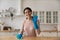 Portrait of smiling female vlogger advertizing new home cleaning products