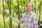 Portrait of smiling gardener standing at plant nursery