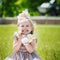 Portrait of smiling girl holding her favourite soft toy in summer day, happy childhood concept