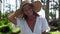 Portrait of smiling girl vacationer in straw hat among the palms