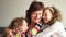 Portrait of smiling grandmother and grandchildren hugging. Grandmother and grandson and granddaughter, close portrait