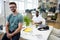 Portrait of smiling graphic designer sitting on his desk