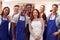 Portrait Of Smiling Group Of Students Wearing Aprons Taking Part In Cookery Class In Kitchen