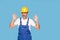 Portrait of smiling handsome adult builder showing okay gesture over blue pastel background