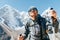 Portrait of smiling Hiker man on Taboche 6495m and Cholatse 6440m peaks background with trekking poles, UV protecting sunglasses.