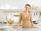 Portrait of smiling housewife in modern kitchen