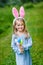 Portrait of smiling little girl with blond hair wearing rabbit ears