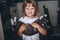 Portrait of a smiling little girl with a kitten in the kitchen interior