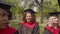 Portrait of smiling lovely black female student in academic dress at graduation ceremony