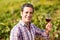 Portrait of smiling male vintner holding a glass of wine