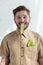 portrait of smiling man with cucumber slice in mouth and savoy cabbage leaf in pocket vegan lifestyle