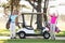 Portrait of smiling mature golfer couple with arms raised