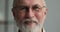 Portrait smiling mature male with grey beard moustache wearing glasses