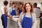 Portrait Of Smiling Mature Woman Wearing Apron Taking Part In Cookery Class In Kitchen