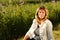 Portrait of a smiling middle age woman relxing in the meadow