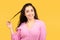 Portrait of smiling millennial middle eastern female tourist touching hair, flirting