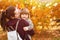 Portrait smiling mother and daughter in autumn park, forest, walking in fresh air, happy childhood, motherhood, copy space