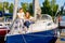 Portrait of smiling mother and daughter on prow of sailboat or yacht
