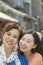 Portrait of smiling mother and daughter on the street in Beijing, close up