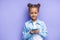 Portrait of smiling mulatto kid girl with mobile phone
