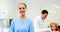 Portrait of smiling nurse standing in clinic