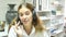 Portrait of smiling polite friendly woman helpline operator with headphones during work in call center