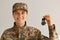 Portrait of smiling positive optimistic military woman wearing camouflage uniform and cap, standing looking at camera with happy