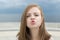 Portrait of smiling pretty beautiful attractive caucasian woman girl with blown air kiss