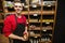 Portrait of smiling salesperson holding jar in supermarket