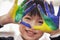 Portrait of smiling schoolboy finger painting, close up on hands