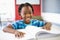 Portrait of smiling schoolboy reading book in classroom