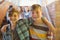 Portrait of smiling schoolboys standing with arm around in corridor