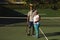 Portrait of smiling senior african american couple with tennis rackets on tennis court