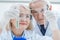 Portrait of smiling senior couple of scientists looking at test tubes