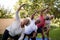 Portrait of smiling senior friends exercising with arms raised