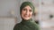 Portrait Of Smiling Senior Muslim Woman In Traditional Hijab Indoor