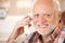 Portrait of smiling senior using landline phone